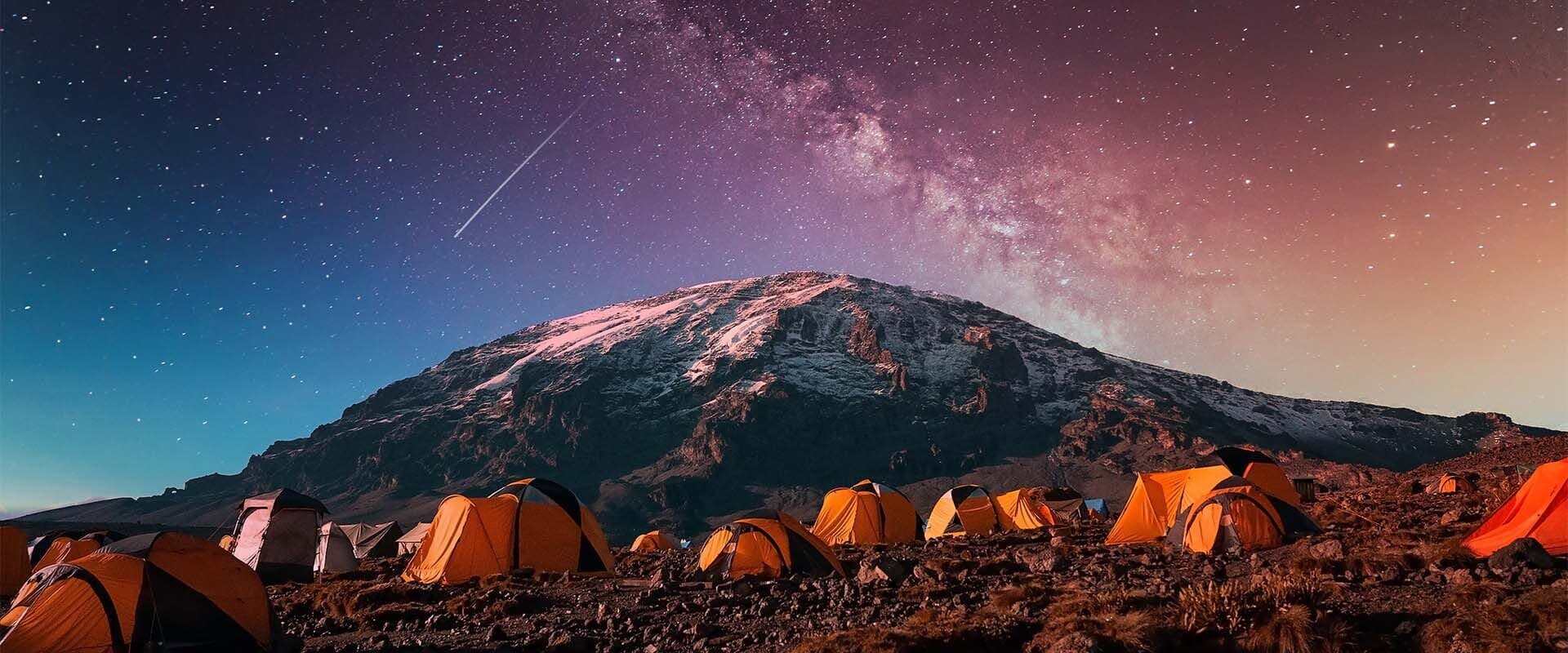 Tents under the Milky Way below Mount Kilimanjaro's summit
